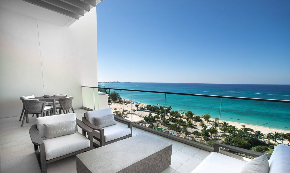 a balcony with chairs and a beach view from Seafire Residence Cayman